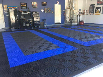 Garage with installed blue and black modular floor tiles