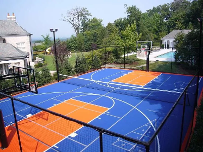 Blue and orange multi-purpose court with basketball hoops, net and line markings